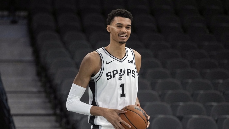 San Antonio Spurs' Victor Wembanyama, the No. 1 draft pick, handles a ball during an NBA basketball press conference, Saturday, June 24, 2023, at the AT&T Center in San Antonio. (AP Photo/Eric Gay)