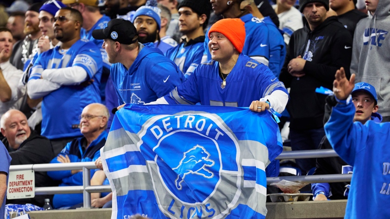 Detroit Lions fans hold up signs against the Los Angeles Rams during an NFL wild-card playoff football game, Sunday, Jan. 14, 2024, in Detroit. (AP Photo/Rick Osentoski)