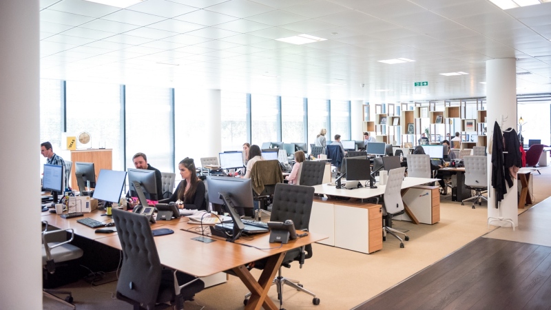 A stock photo of people working in an office. (unsplash/Arlington Research)