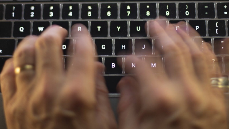 A man uses a computer keyboard in Toronto in this photo illustration. THE CANADIAN PRESS/Graeme Roy