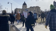 Teachers picket outside of the Saskatchewan Legislative Building ahead of the provincial budget on March 20, 2024. (Cole Davenport/CTV News)
