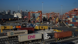 Trucks carrying cargo containers arrive at the Port of Vancouver Centerm container terminal, in Vancouver, on Friday, October 14, 2022. THE CANADIAN PRESS/Darryl Dyck