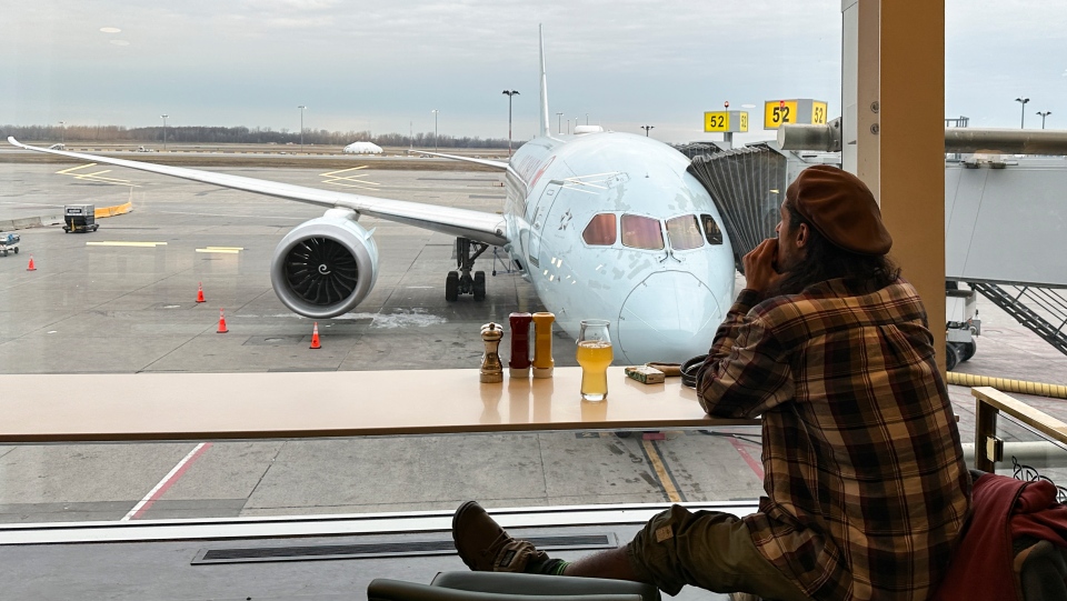 A traveller looks at an Air Canada plane