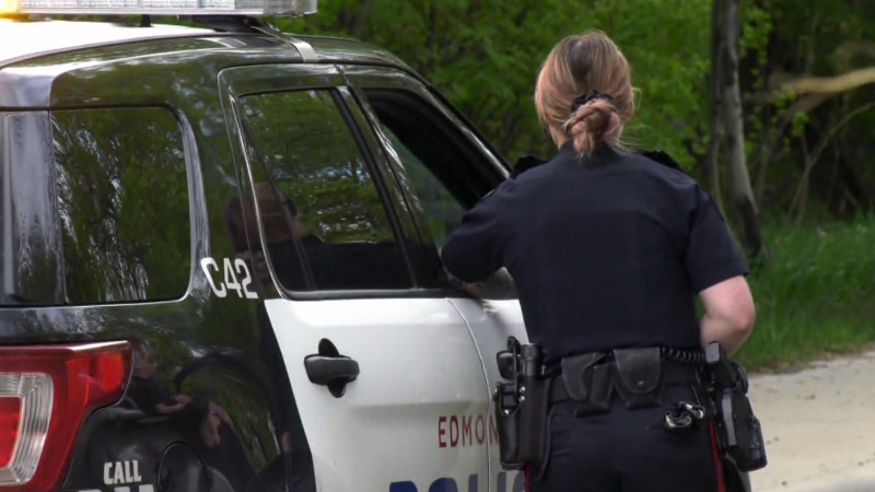 An Edmonton Police Service officer stands next to a cruiser in a file photo. (Matt Marshall/CTV News Edmonton)