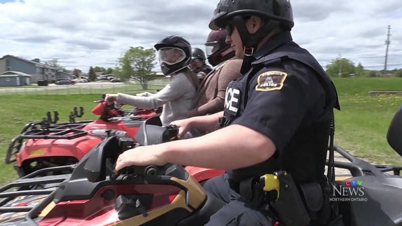 OPP officer rides next to ATV drivers. June 3, 2024 (Sergio Arangio/CTV Northern Ontario)