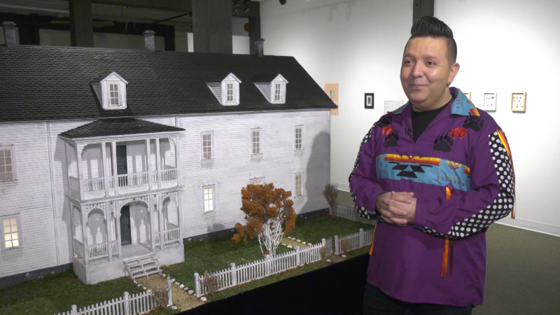 Artist Lance Cardinal next to his miniature replica of the St. Martin's Residential School. (Matt Marshall/CTV News Edmonton)