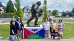 Members of Peepeekisis Cree Nation with the Regina Rifles statue at its permanent home in Normandy, France. (Rhonda Nye / CTV News) 