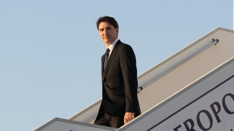 Prime Minister Justin Trudeau disembarks a government plane as he arrives in Deauville, France, Wednesday, June 5, 2024. (Adrian Wyld/The Canadian Press)