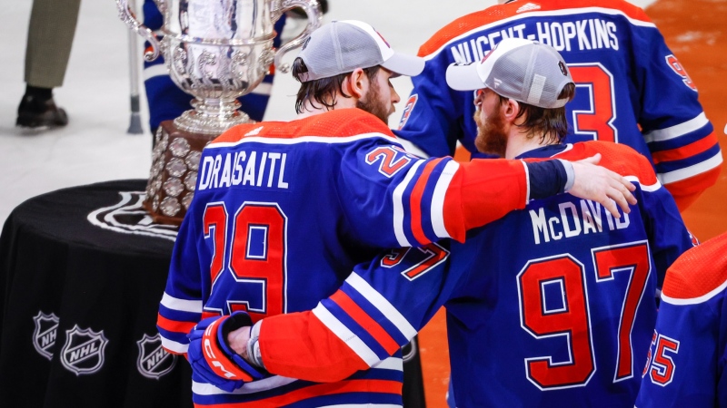 Edmonton Oilers forward Connor McDavid (97) and forward Leon Draisaitl (29) embrace after defeating the Dallas Stars in Game 6 of the Western Conference finals of the NHL hockey Stanley Cup playoffs in Edmonton, Sunday, June 2, 2024.THE CANADIAN PRESS/Jeff McIntosh