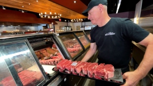 Mike Cantor, owner of The Butchery, stocks cuts of meat in the store. Cantor says barbecue season is off to a strong start this year. (Dave Charbonneau/CTV News Ottawa)