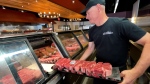 Mark Cantor, owner of The Butchery, stocks cuts of meat in the store. Cantor says barbecue season is off to a strong start this year. (Dave Charbonneau/CTV News Ottawa)
