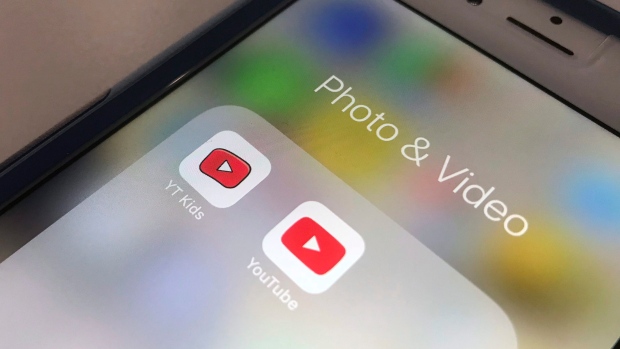 FILE - In this Wednesday, April 25, 2018, file photo, the YouTube app and YouTube Kids app are displayed on a smartphone in New York. (AP Photo/Jenny Kane, File)