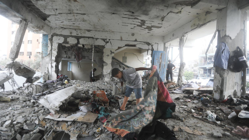 Palestinians look at the aftermath of the Israeli strike on a UN-run school that killed dozens of people in the Nusseirat refugee camp in the Gaza Strip, Thursday, June 6, 2024. (AP Photo/Abdel Kareem Hana)