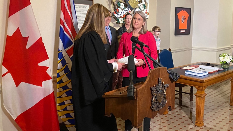 Elenore Sturko, right, is sworn in by clerk Kate Ryan-Lord at the legislature in Victoria, Monday, Oct.3, 2022. THE CANADIAN PRESS/Dirk Meissner