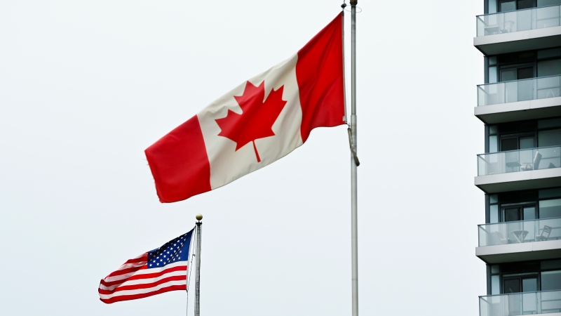 American and Canadian flags fly outside the United States consulate in Toronto on Nov. 3, 2020. (Nathan Denette / The Canadian Press)