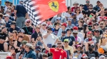 A fan waves a Ferrari flag at the Senna corner during the second practice session at the Formula One Canadian Grand Prix in Montreal, Friday, June 17, 2022. (Graham Hughes, The Canadian Press)