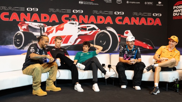 Mercedes driver Lewis Hamilton of Great Britain, from L-R, pours his new non-alcoholic drink Almave to fellow drivers Haas driver Nico Hulkenberg of Germany, Aston Martin driver Lance Stroll of Canada, Alpine driver Pierre Gasly of France and McLaren driver Oscar Piastri of Australia during the drivers' press conference at the Canadian Grand Prix Thursday, June 6, 2024 in Montreal. (THE CANADIAN PRESS/Christinne Muschi)