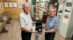 Bill Munroe and Gordon McKenzie of the Plympton-Wyoming Museum stand in one of three display rooms featuring D-Day memorabilia on June 6, 2024. (Sean Irvine/CTV News London)