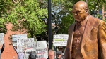 Protesters attend the unveiling of a statue of Sir Winston Churchill in Calgary on June 6, 2024. (Timm Bruch/CTV News) 