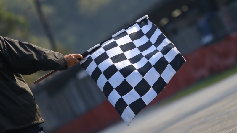 This image shows a checkered flag at a racetrack. (Credit: Shutterstock) 