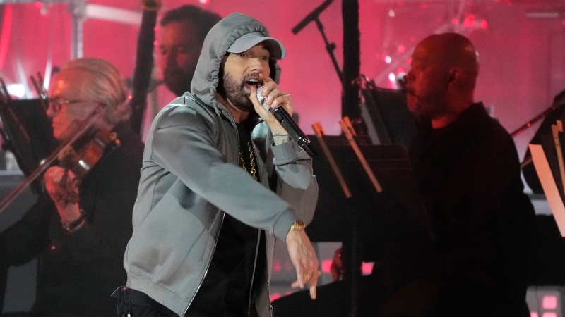 Eminem performs during a concert celebrating the historic reopening of a an 18-story structure that long had symbolized their hometown's decline. Diana Ross, Eminem and Jack White took part in Thursday night's event called "Live From Detroit: The Concert at Michigan Central." Thursday, June 6, 2024, in Detroit. (AP Photo/Carlos Osorio)
