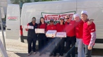 Staff with Winnipeg's Krispy Kreme location hand out free samples of their doughnuts in Osborne Village on June 7, 2024. (Joseph Bernacki/CTV News Winnipeg)