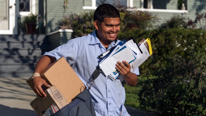 United States Postal Service letter carrier Gabriel Peña works in Los Angeles on March 22, 2024. (Damian Dovarganes / AP Photo)