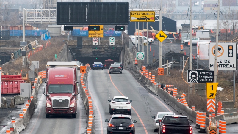 Vehicles enter and exit the Louis-Hippolyte-La Fontaine Tunnel on the south shore of Montreal, Monday, January 2, 2023. THE CANADIAN PRESS/Graham Hughes