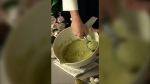 A person scoops pistachio ice cream. (Pexels)