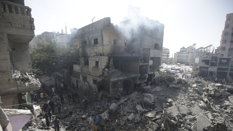Palestinians look at the aftermath of the Israeli bombing in Nuseirat refugee camp, Gaza Strip, Saturday, June 8, 2024. (AP Photo/Jehad Alshrafi)