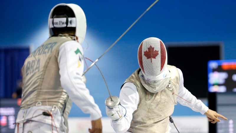 Canada's Maximilien Van Haaster, right, competes against Brazil's Ghislain Perrier during their men's foil individual quarterfinal match at the Pan Am Games, Wednesday, July 22, 2015, in Toronto. (Julio Cortez, The Associated Press)