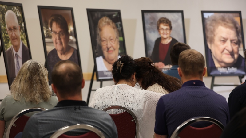 Loved ones look on as photos of  individuals who died in a June 15 highway crash near Carberry are displayed during a press conference in Dauphin, Man., on Thursday, June 22, 2023. (The Canadian Press/The Brandon Sun - Tim Smith)