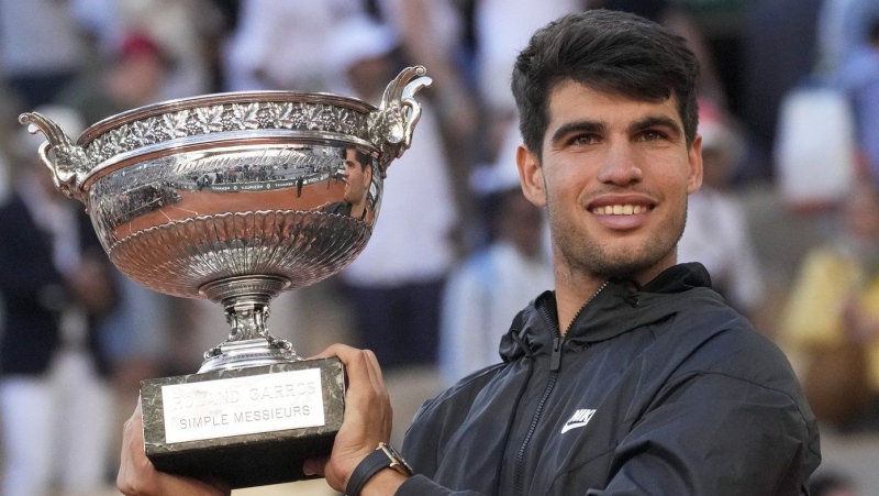Carlos Alcaraz holds the trophy after winning the men's final of the French Open tennis tournament on June 9, 2024. (Christophe Ena/AP Photo)