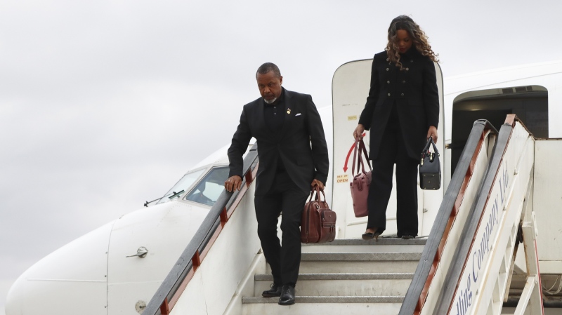 Malawi Vice-President Saulos Chilima, left, and his wife Mary disembark from a plane upon his return from South Korea in Lillongwe, June 9, 2024. (AP Photo)