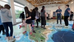 Students were invited to try out the Parks Canada and Canadian Geographic giant floor map in Ottawa, Ont. on June 10, 2024. (Tyler Fleming / CTV News).