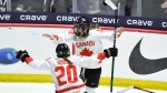 Canada forward Danielle Serdachny, right, celebrates with forward Sarah Nurse after scoring the winning goal against the United States during overtime in the final at the women's world hockey championships in Utica, N.Y., Sunday, April 14, 2024. (AP Photo/Adrian Kraus)