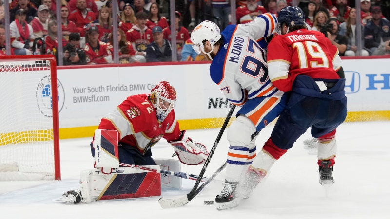 Florida Panthers goalie Sergei Bobrovsky and winger Matthew Tkachuk defend the net as Edmonton Oilers centre Connor McDavid closes in during Game 2 of the NHL Stanley Cup Final on June 10, 2024, in Sunrise, Fla. (Wilfredo Lee/Associated Press)