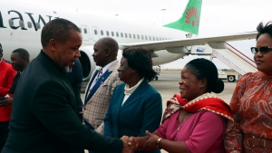 Malawi Vice President Saulos Chilima, left, greets government officials upon his return from South Korea in Lillongwe, Sunday, June 9, 2024. (AP Photo)
