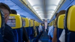 Passengers are seen in their seats in the cabin of an airplane. (Domenico Bandiera / Pexels)