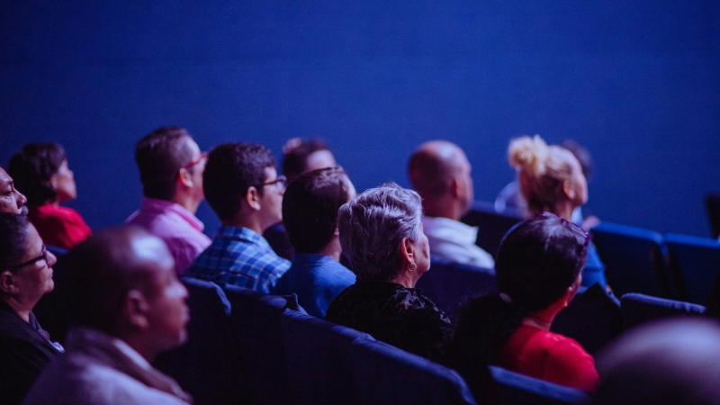 Moviegoers are shown seated in a theatre. A new study of LGBTQ+ representation in Canadian film, TV, streaming and video game industries says there are significant gaps in how the diverse community is portrayed on screen. (Pexels)