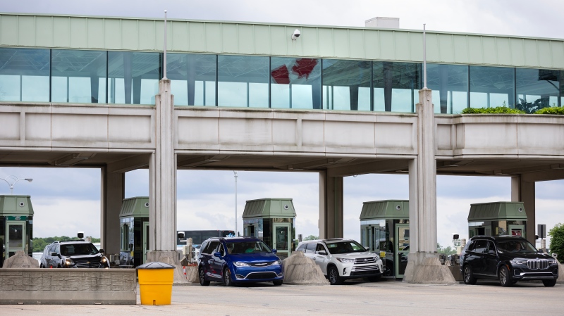 Canada Border Services Agency officers speak with travellers crossing at the Niagara Falls International Rainbow Bridge in Niagara Falls, Ontario Friday, June 7, 2024. (Aaron Lynett / The Canadian Press)