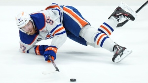 Edmonton Oilers forward Connor McDavid gets tripped up against the Florida Panthers during second period game 2 action of the NHL Stanley Cup finals in Sunrise, Fla., on Monday, June 10, 2024. THE CANADIAN PRESS/Nathan Denette
