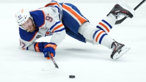 Edmonton Oilers forward Connor McDavid gets tripped up against the Florida Panthers during second period Game 2 action of the NHL Stanley Cup finals in Sunrise, Fla., on Monday, June 10, 2024. (Nathan Denette/CP)
