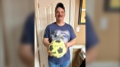 Lee Croucher, shown here in a June 4, 2024, handout photo, found a soccer ball on a beach in Newfoundland that appears to be from a school in Pond Inlet, Nvt. (Handout via Jane Croucher) 
