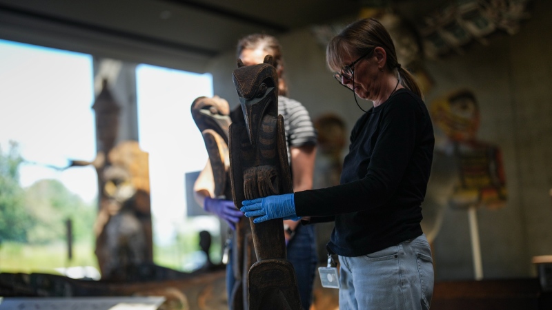An employee moves a carving as staff and construction workers prepare for the reopening of the Museum of Anthropology, which has been closed for 18-months, in Vancouver, B.C., Tuesday, June 11, 2024. The Great Hall was fully rebuilt with seismic upgrades taking place to protect the collections in the event of a major earthquake. Displays in the gallery spaces have also been revitalized and reinterpreted, in collaboration with First Nations communities and families whose objects and belongings are housed at the museum. THE CANADIAN PRESS/Darryl Dyck