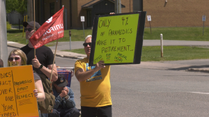 Man holds sign that says 'Only 4% of paramedics make it to retirement' during paramedic picket in front of the Sault social services building on Albert Street. June 11, 2024 (Mike McDonald/CTV Northern Ontario)
