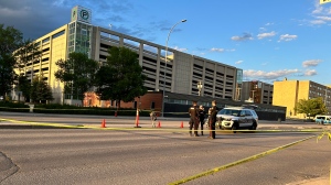 Police officers blocked off a portion of Notre Dame Avenue Tuesday evening following an officer-involved shooting on June 11, 2024. (Jon Hendricks/CTV News)