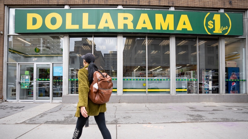A person walks past a Dollarama store in Montreal, Wednesday, June 7, 2023. THE CANADIAN PRESS/Christinne Muschi