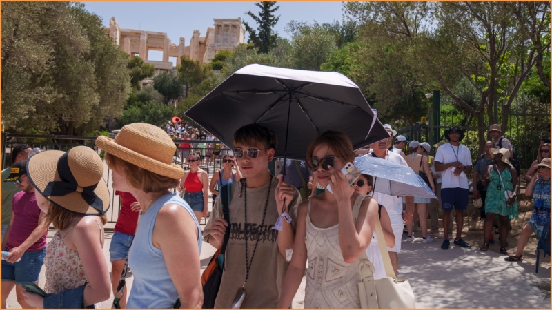 Tourists exit the ancient Acropolis in central Athens on Wednesday, June 12, 2024. (AP Photo/Petros Giannakouris)