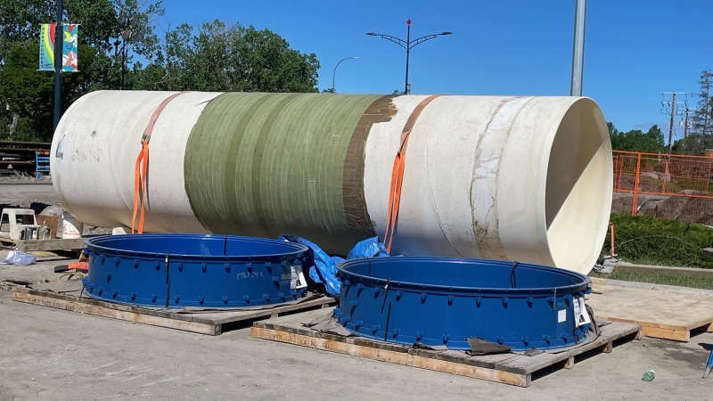 A new length of feeder main pipe sits at the ready for city crews to put into place, nearly a week after the old water main broke, flooding a section of northwest Calgary.